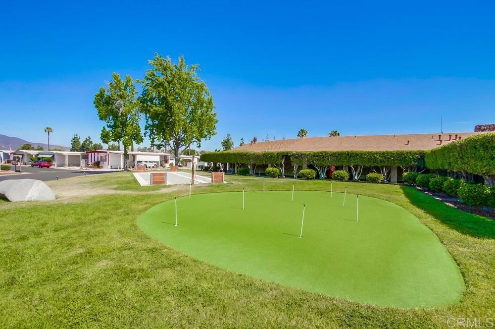 8301 Mission Gorge Road, Unit 194 Santee, CA 92071 - Photo 56 of 61 a view of a swimming pool with a yard and palm trees