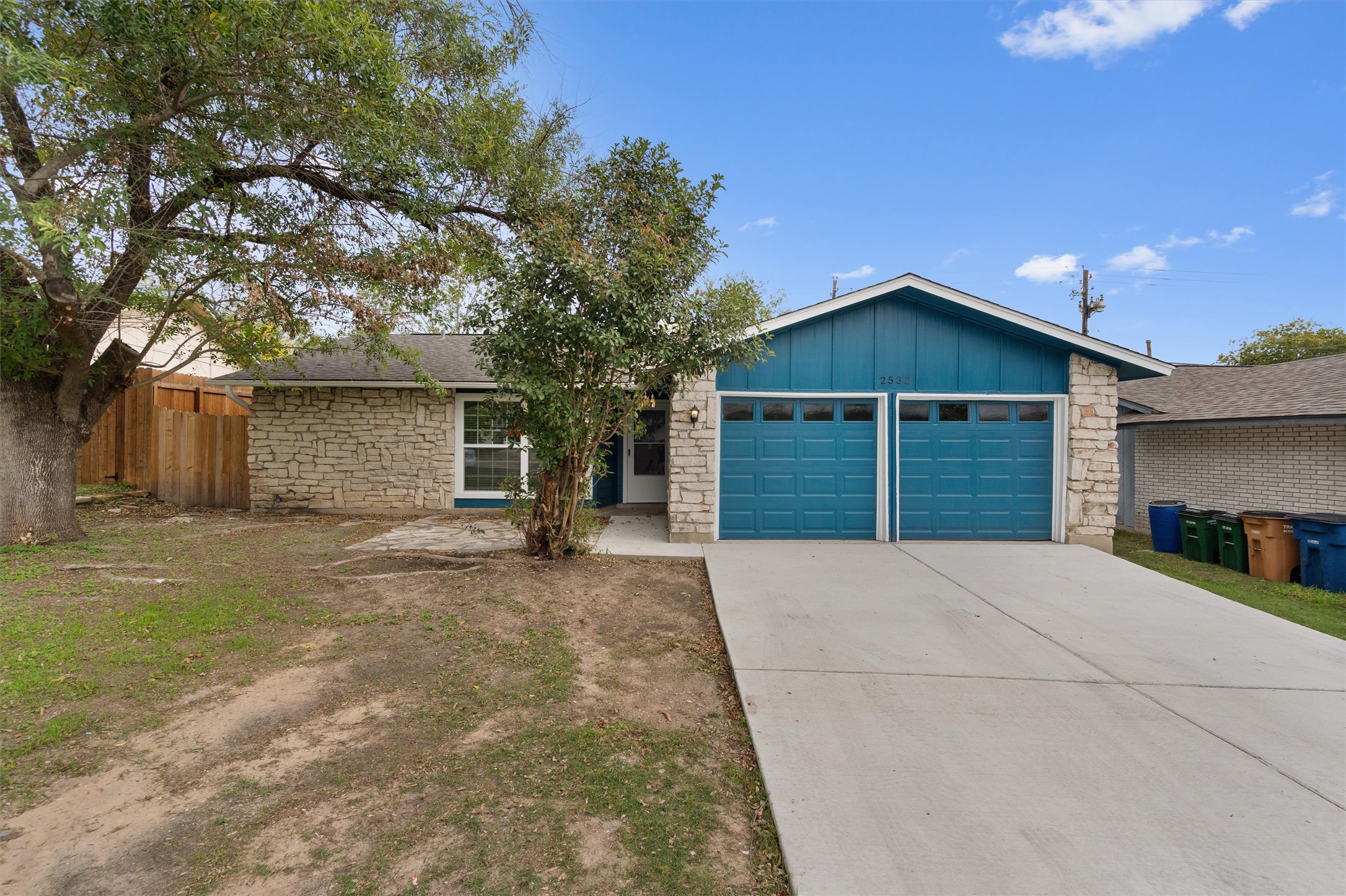 2532 Chaparral Trail Austin, TX 78744 - Photo 1 of 27 a front view of a house with a yard and garage