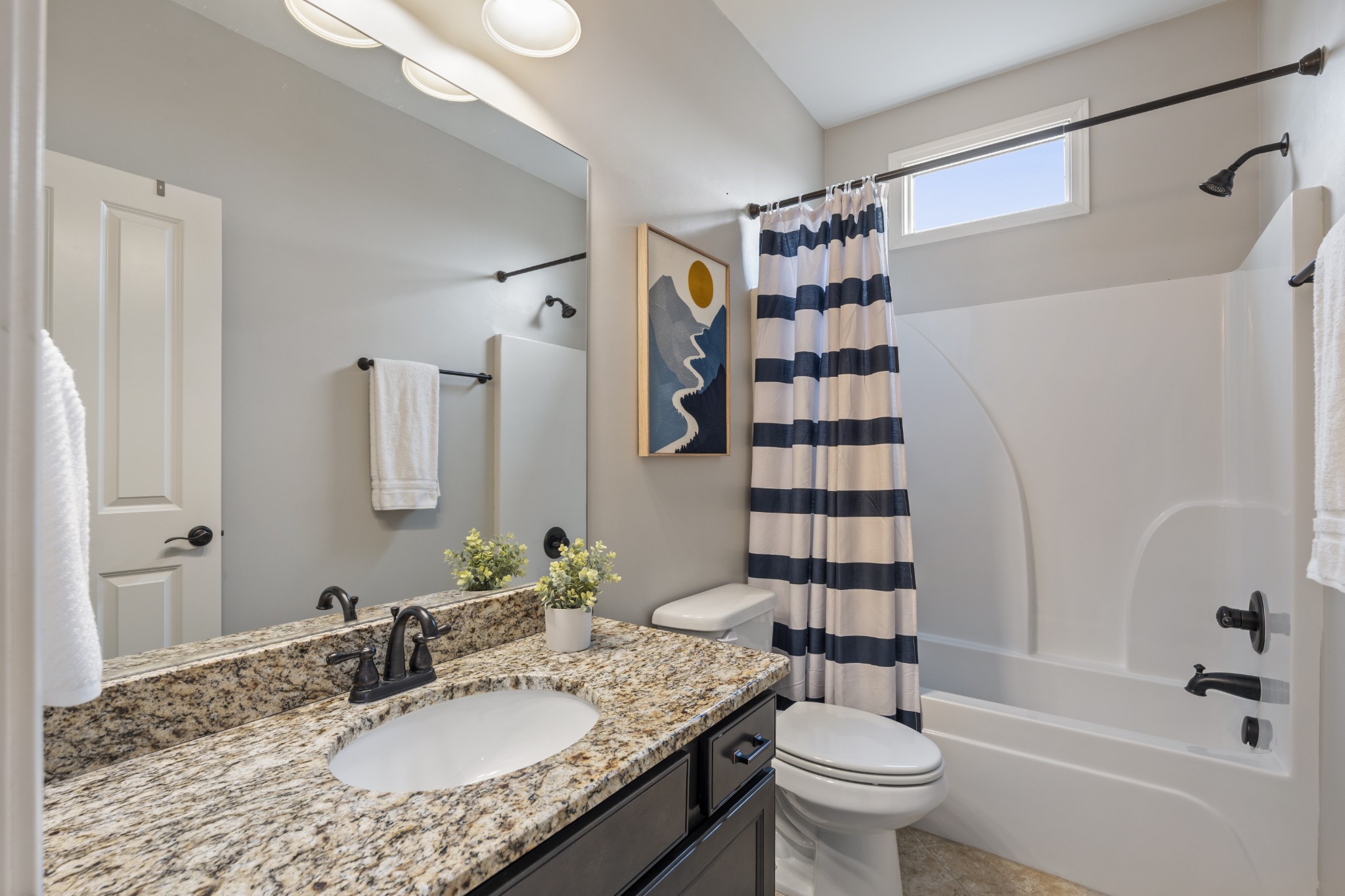 2069 Rural Plains Circle Franklin, TN 37064 - Photo 24 of 74 a bathroom with a granite countertop sink a toilet and shower