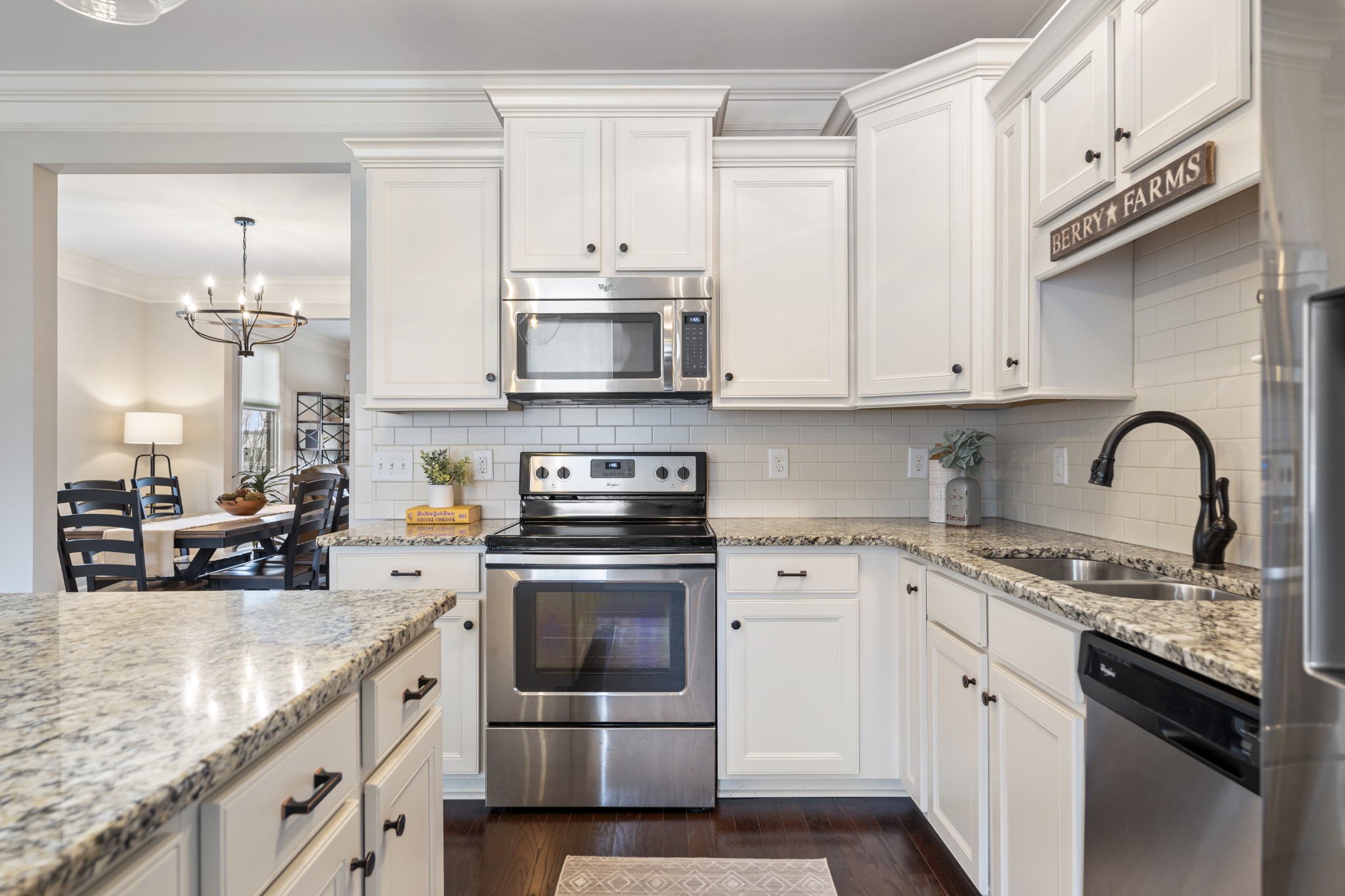 2069 Rural Plains Circle Franklin, TN 37064 - Photo 9 of 74 a kitchen with stainless steel appliances granite countertop a stove a sink and a microwave