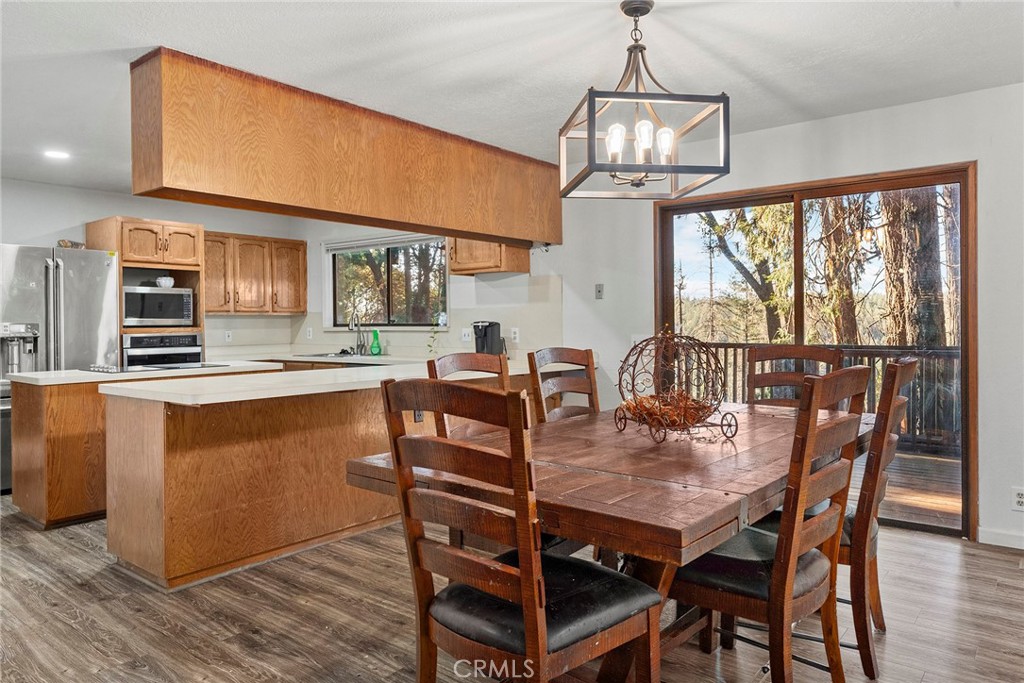 14177 Racine Circle Magalia, CA 95954 - Photo 11 of 52 a view of a dining room with furniture window and wooden floor