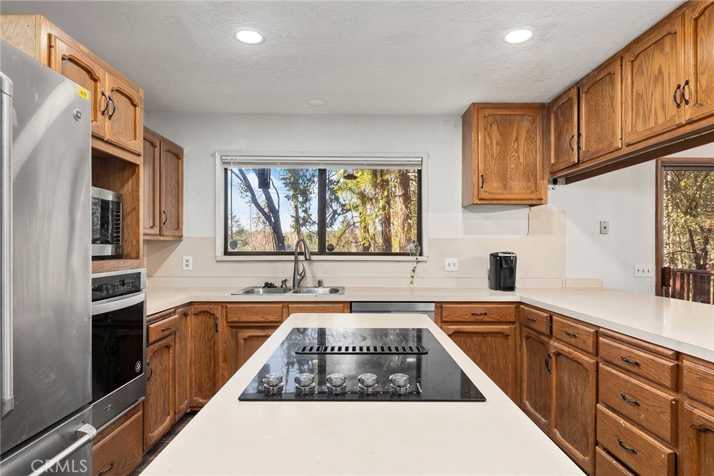14177 Racine Circle Magalia, CA 95954 - Photo 14 of 52 a kitchen with a sink stove and cabinets