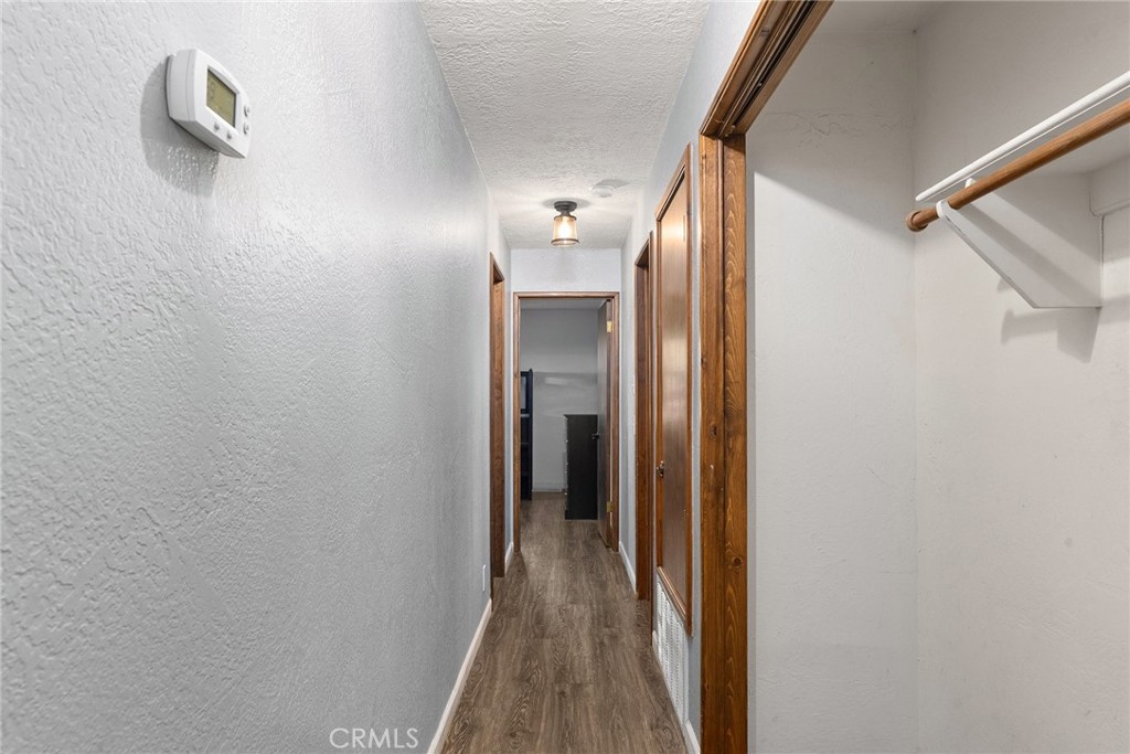 14177 Racine Circle Magalia, CA 95954 - Photo 23 of 52 a view of a hallway with wooden floor and closet