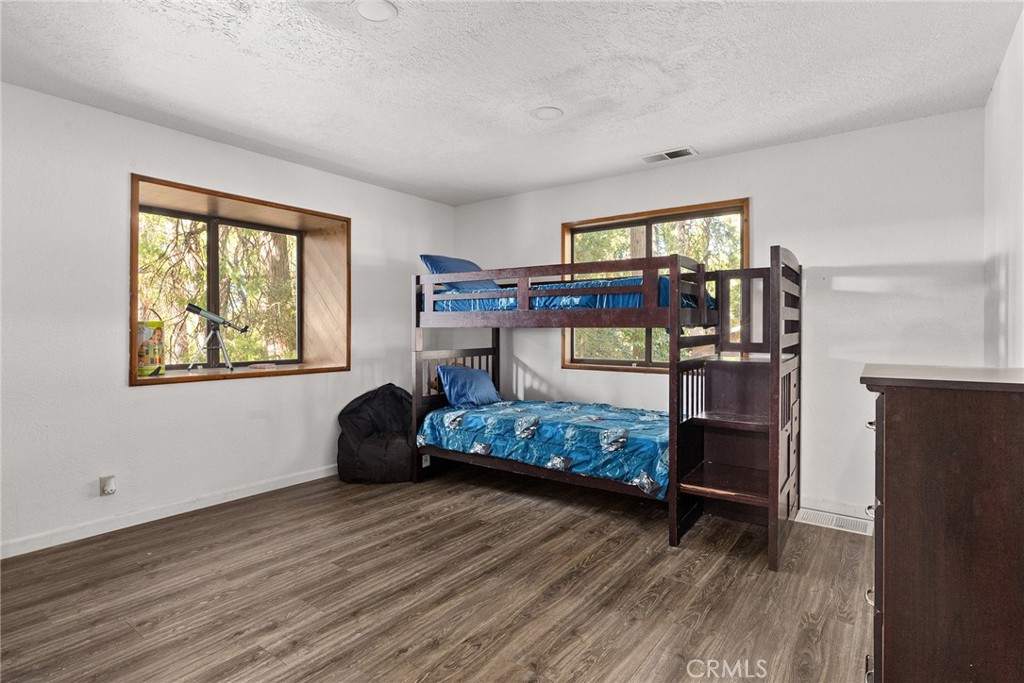 14177 Racine Circle Magalia, CA 95954 - Photo 34 of 52 a bedroom with a bed and wooden floor