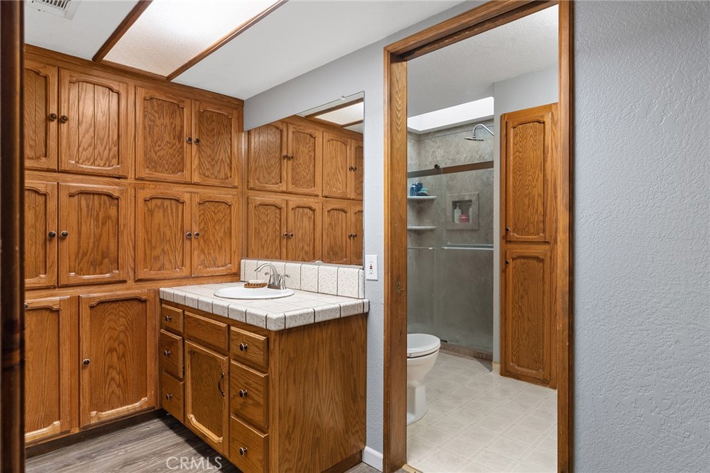 14177 Racine Circle Magalia, CA 95954 - Photo 35 of 52 a bathroom with a granite countertop sink and a mirror