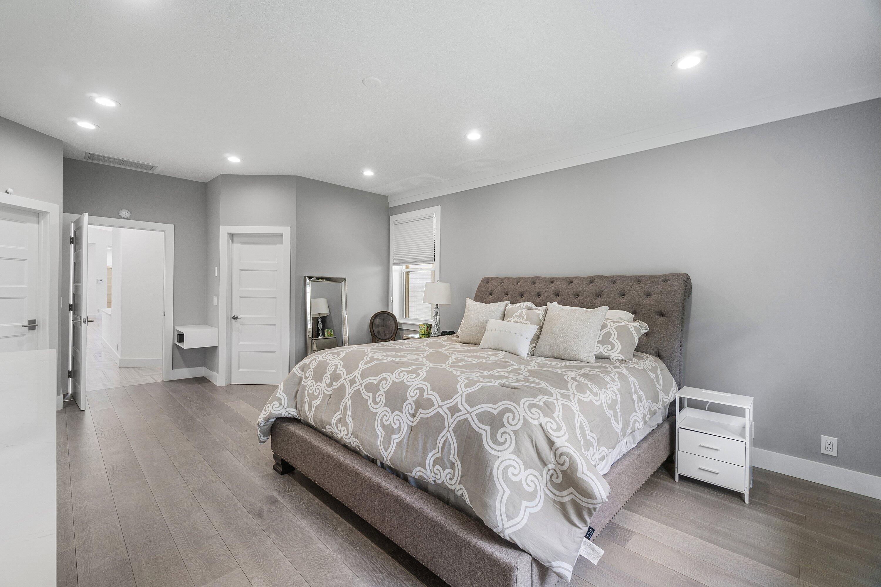 2404 Northwest 67th Street Boca Raton, FL 33496 - Photo 21 of 74 a spacious bedroom with a bed and a couch