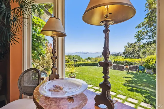 a dining room with furniture and a floor to ceiling window