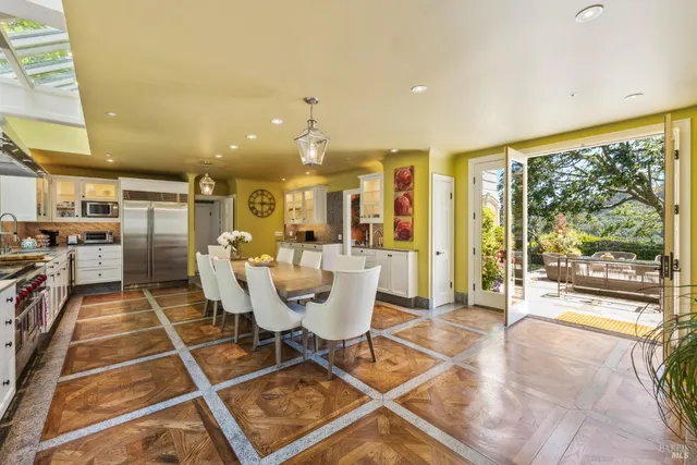 a large kitchen with a table and chairs