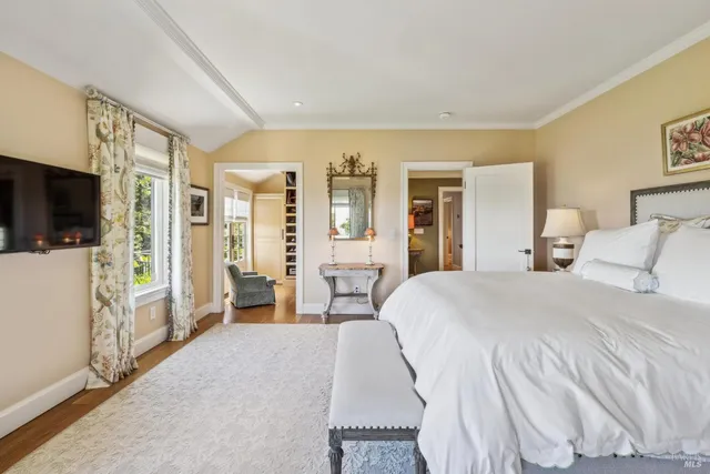 a large white bathroom with a sink mirror and window