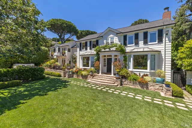 a front view of a house with a garden