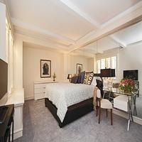 Undisclosed Address Manhattan, NY 10019 - Photo 3 of 6 a spacious bedroom with a bed a couch and a flat tv screen