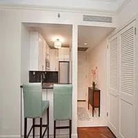 a kitchen with granite countertop cabinets and chairs
