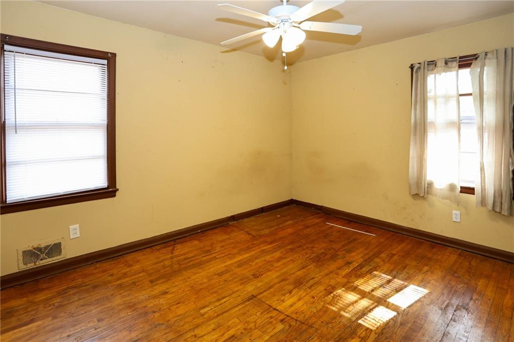 1368 West Austin Road Decatur, GA 30032 - Photo 11 of 42 a view of an empty room with wooden floor and a window