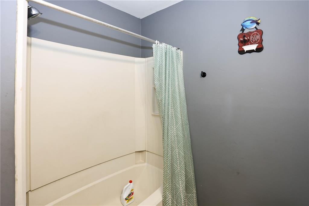 1368 West Austin Road Decatur, GA 30032 - Photo 16 of 42 a bathroom with a bathtub and a shower