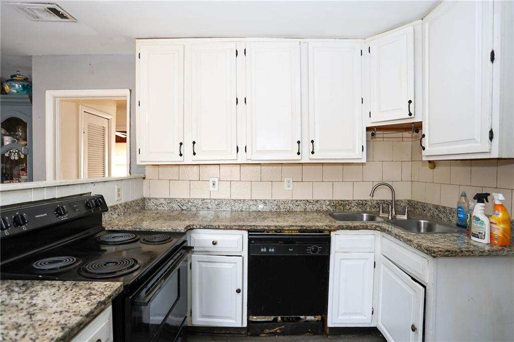 1368 West Austin Road Decatur, GA 30032 - Photo 21 of 42 a kitchen with granite countertop a sink a stove and cabinets