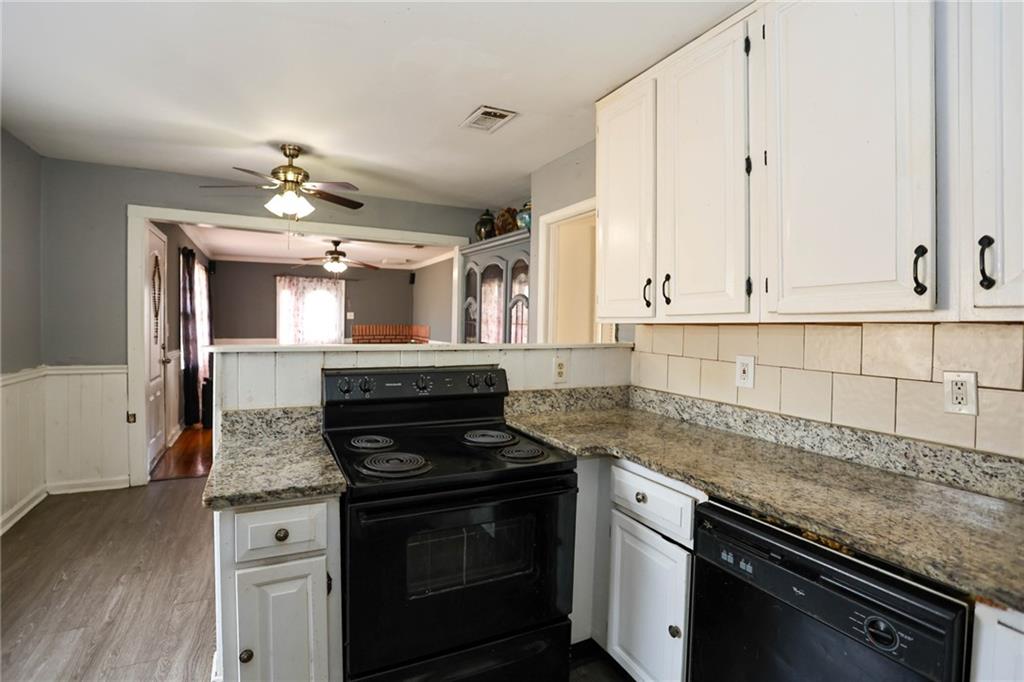 1368 West Austin Road Decatur, GA 30032 - Photo 22 of 42 a kitchen with granite countertop white cabinets and stainless steel appliances