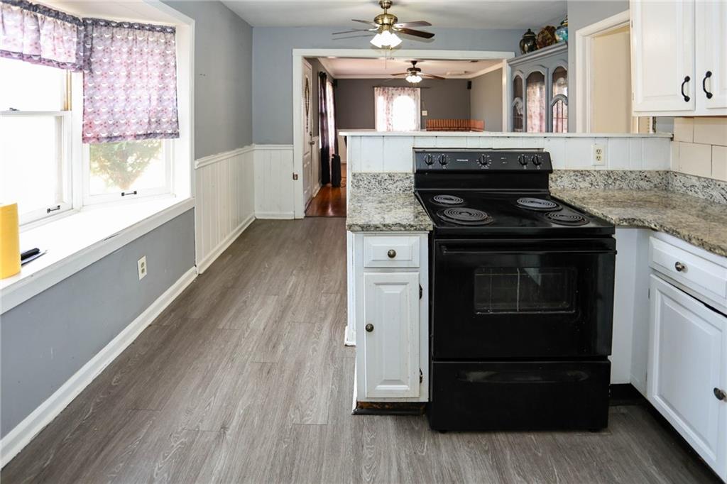 1368 West Austin Road Decatur, GA 30032 - Photo 23 of 42 a kitchen with a stove and a wooden floor