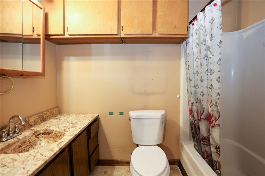 1368 West Austin Road Decatur, GA 30032 - Photo 28 of 42 a bathroom with a granite countertop sink a toilet and a window