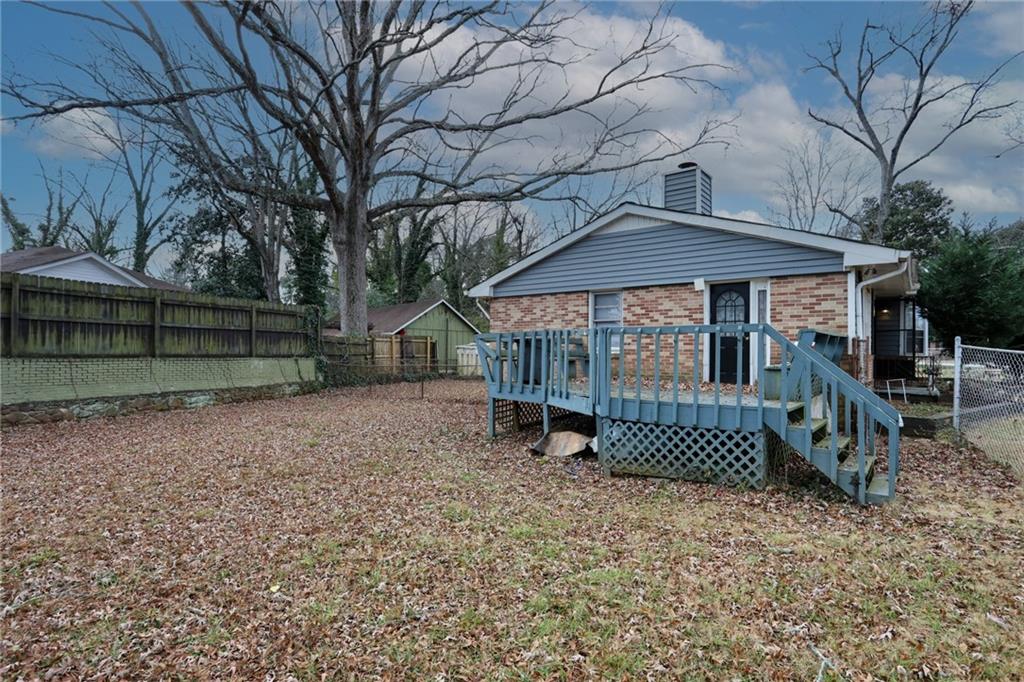 1368 West Austin Road Decatur, GA 30032 - Photo 39 of 42 a small house with a table and chairs under an umbrella
