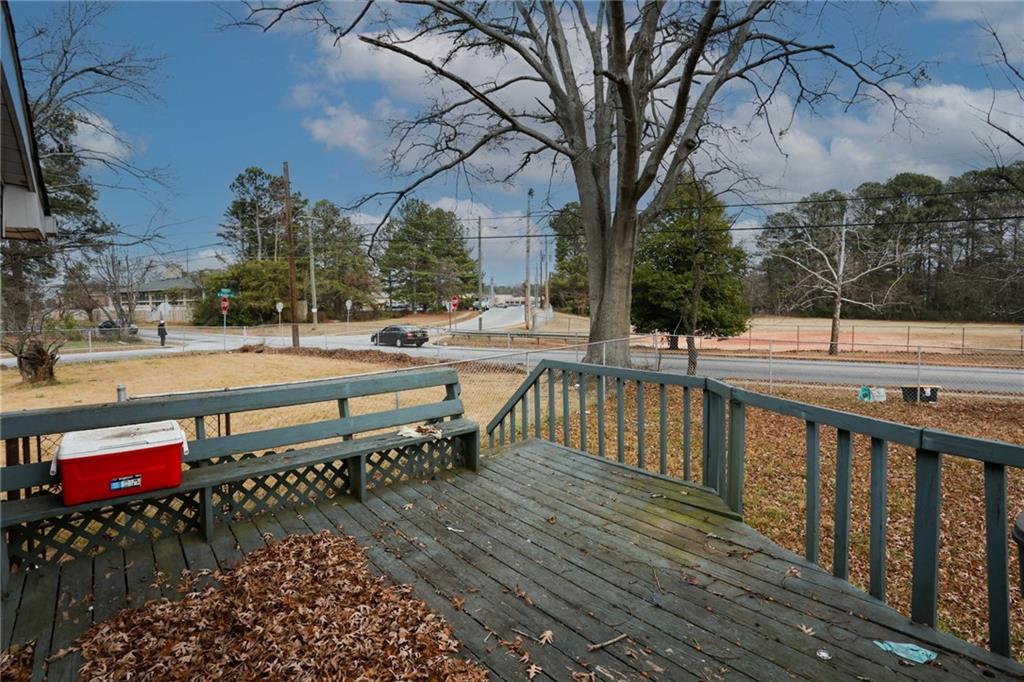 1368 West Austin Road Decatur, GA 30032 - Photo 42 of 42 a balcony with wooden benches and trees