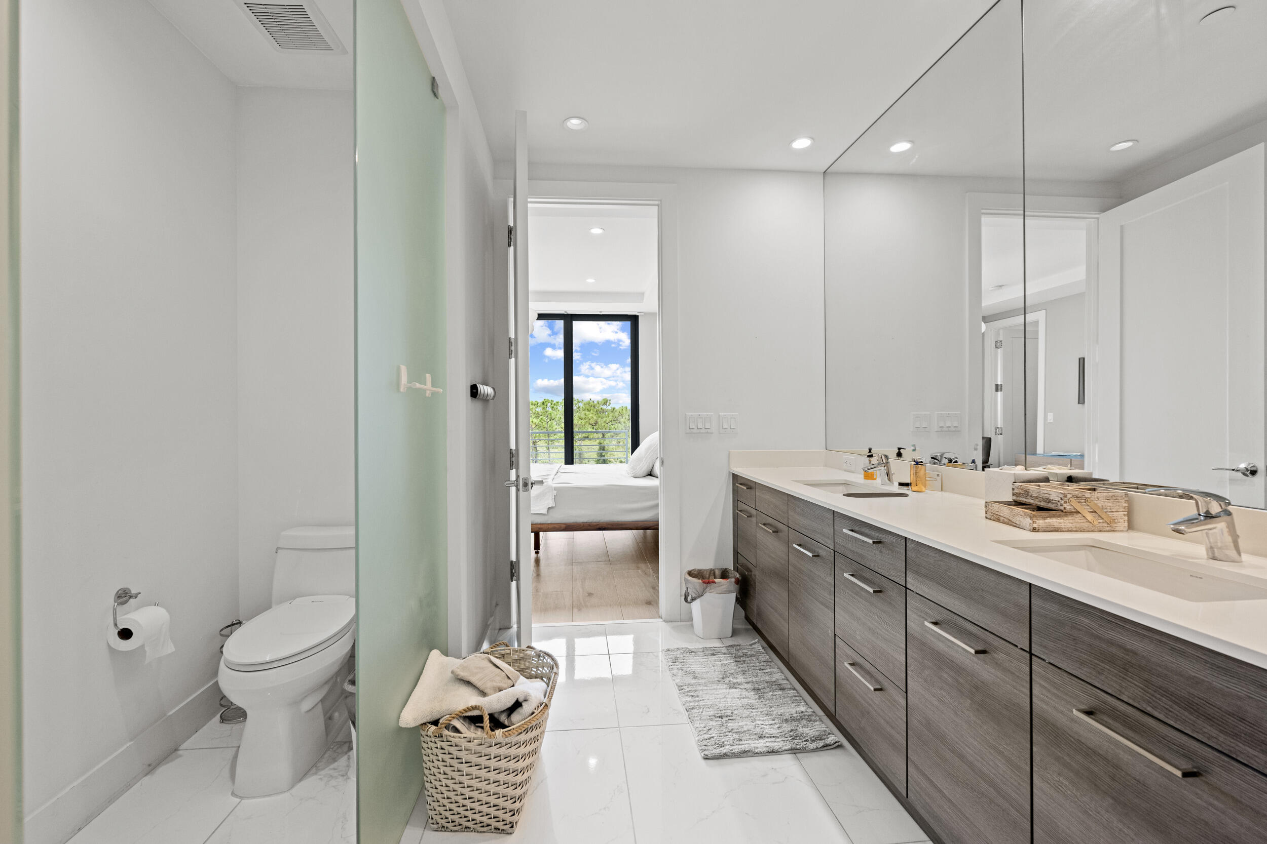 1811 Northwest 42nd Drive Boca Raton, FL 33431 - Photo 34 of 51 a spacious bathroom with a double vanity sink toilet and shower