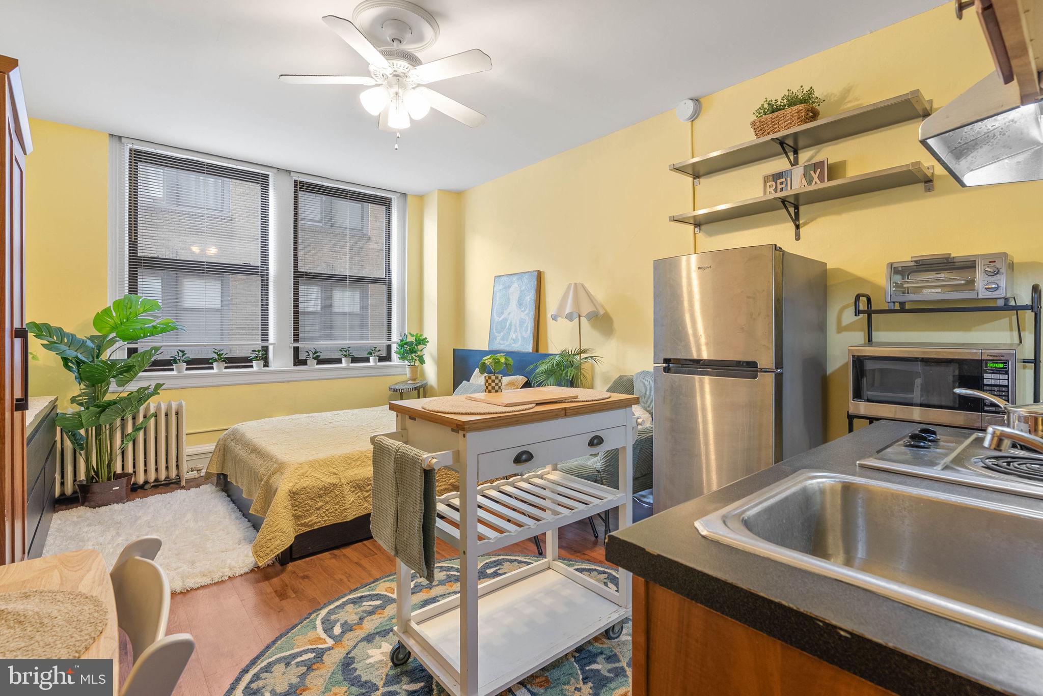 1324 Locust Street, Unit 703 Philadelphia, PA 19107 - Photo 1 of 14 a kitchen with a refrigerator table and chairs