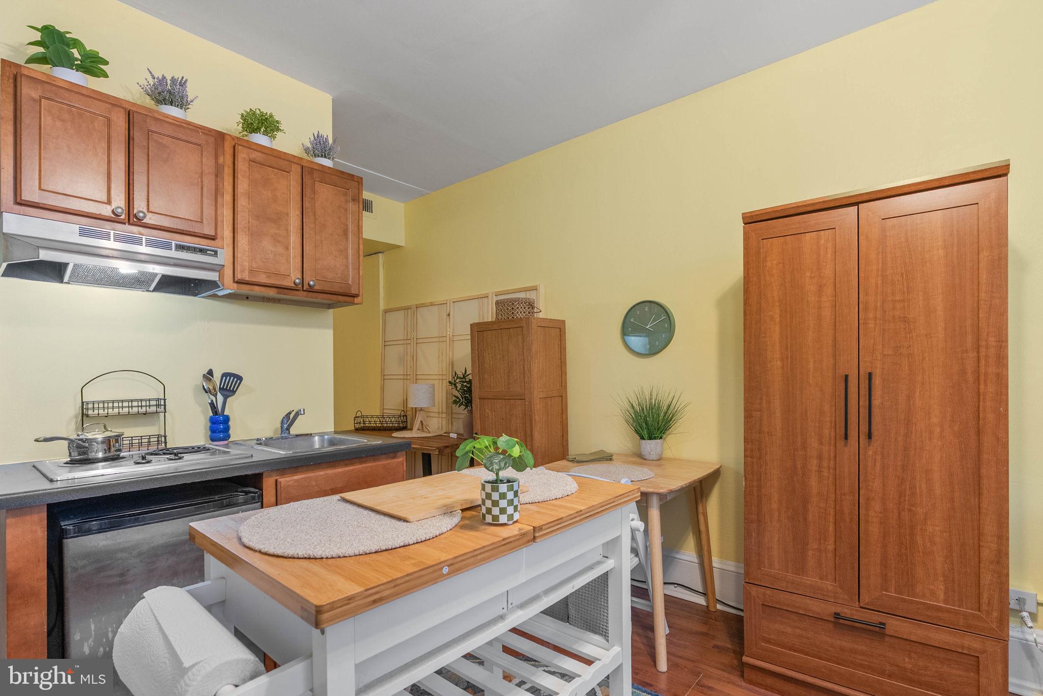 1324 Locust Street, Unit 703 Philadelphia, PA 19107 - Photo 2 of 14 a kitchen with stainless steel appliances granite countertop a sink stove and cabinets