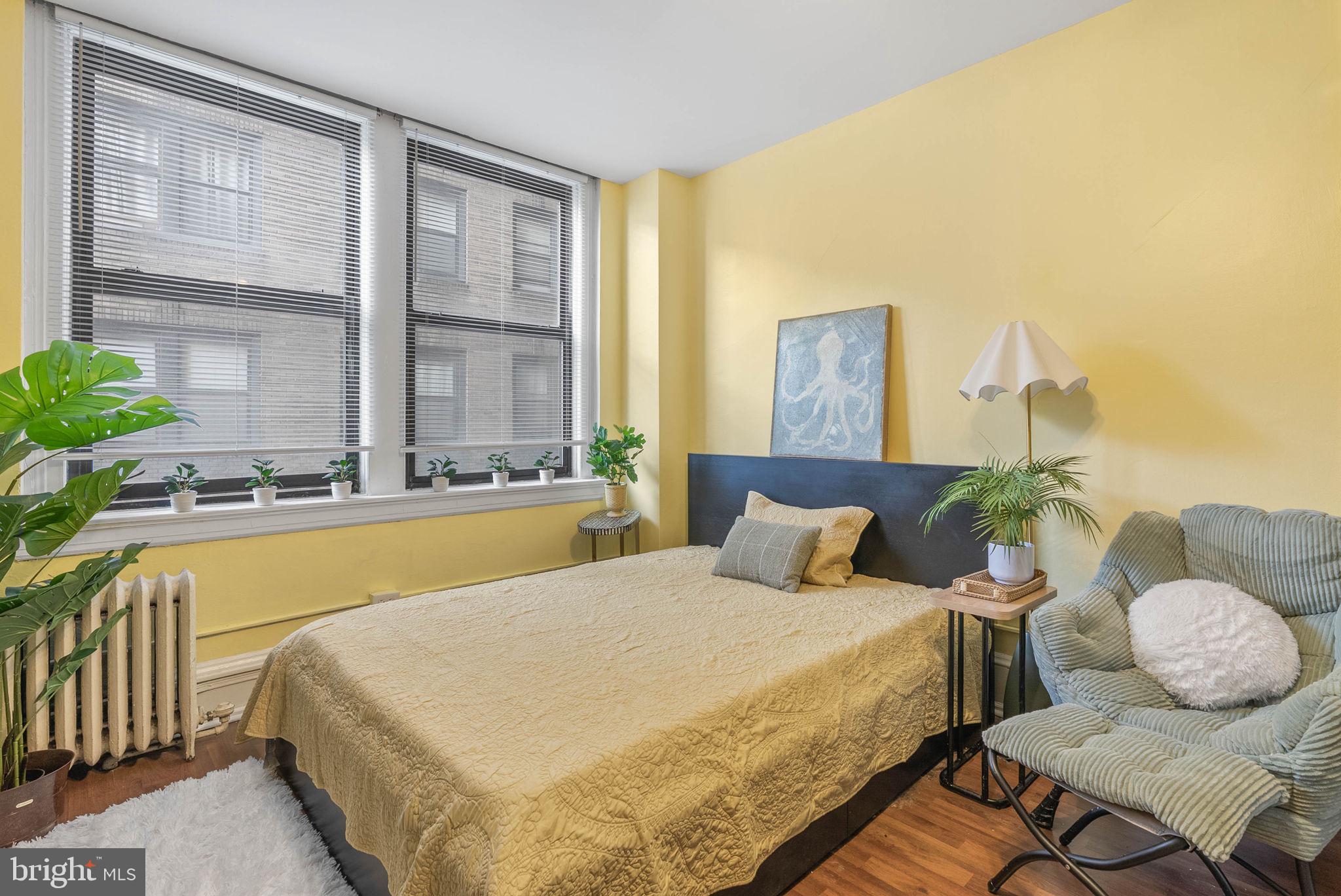 1324 Locust Street, Unit 703 Philadelphia, PA 19107 - Photo 3 of 14 a spacious bedroom with a bed and a couch