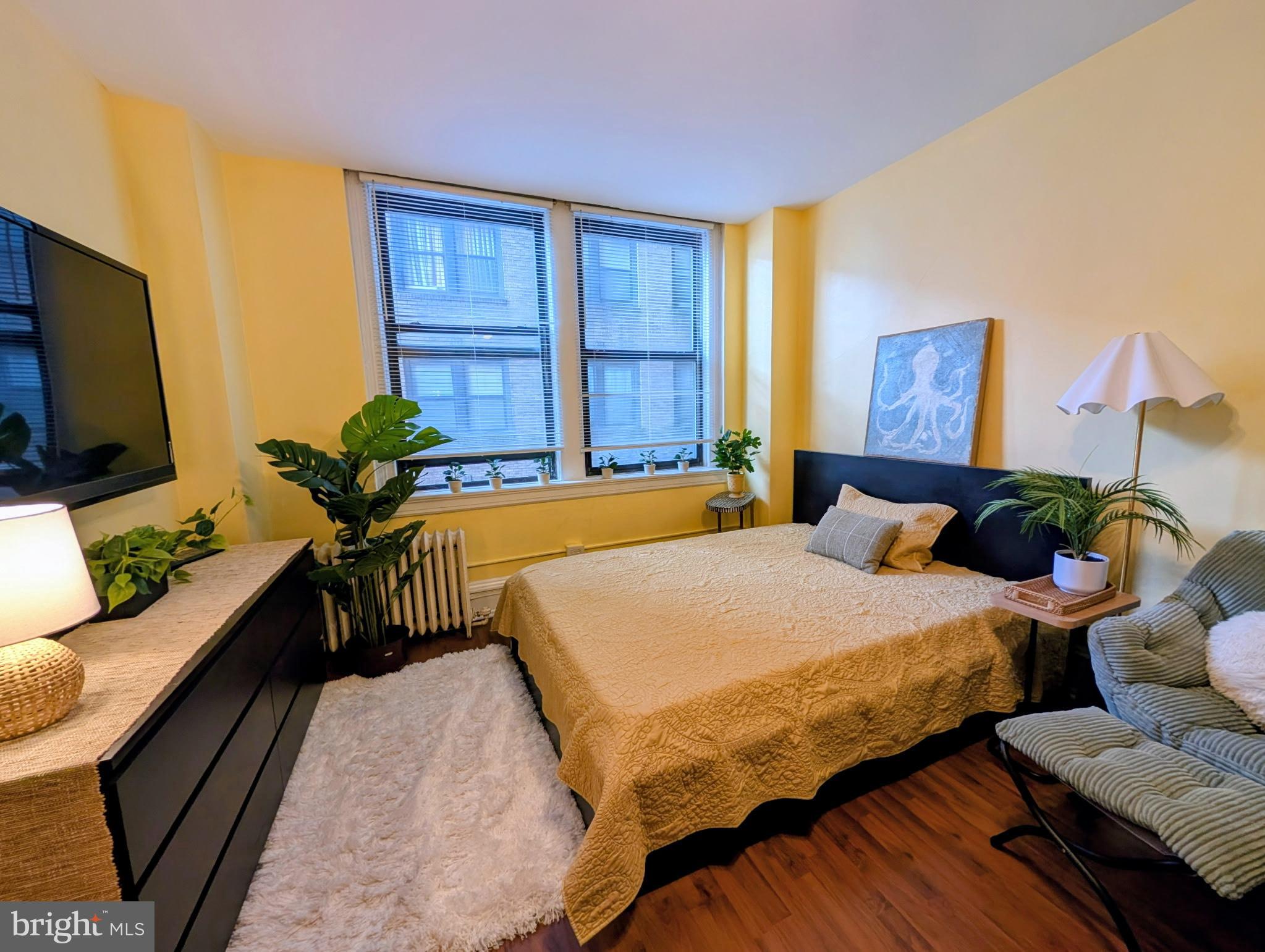 1324 Locust Street, Unit 703 Philadelphia, PA 19107 - Photo 6 of 14 a bedroom with a bed and a couch