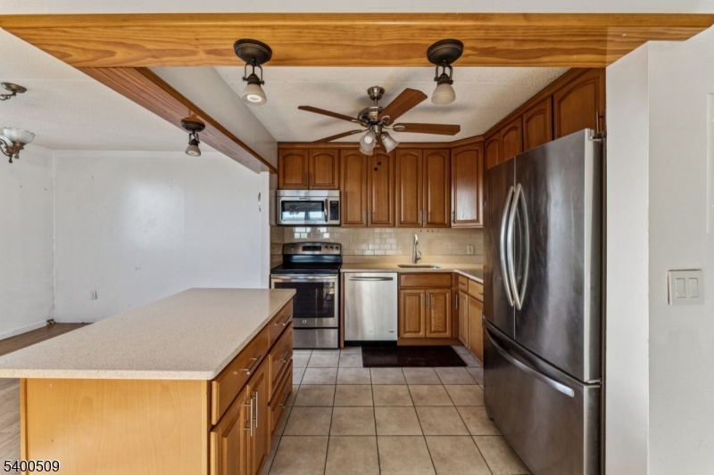 170 Lafayette Avenue, Unit 11E Passaic, NJ 07055 - Photo 12 of 32 a kitchen with stainless steel appliances granite countertop a refrigerator a sink and dishwasher