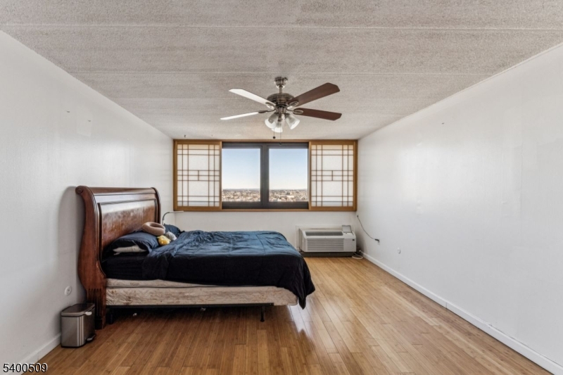 170 Lafayette Avenue, Unit 11E Passaic, NJ 07055 - Photo 17 of 32 a bedroom with a bed and a window