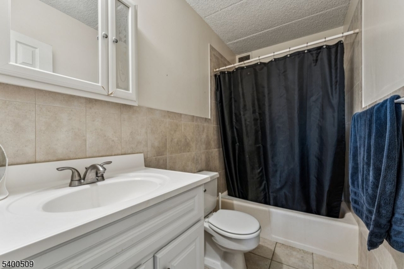 170 Lafayette Avenue, Unit 11E Passaic, NJ 07055 - Photo 18 of 32 a bathroom with a sink and a toilet