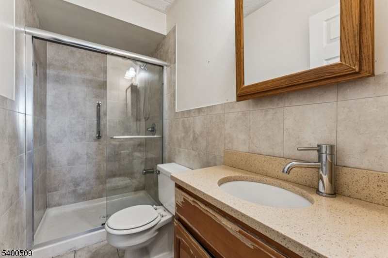 170 Lafayette Avenue, Unit 11E Passaic, NJ 07055 - Photo 19 of 32 a bathroom with a sink toilet and shower