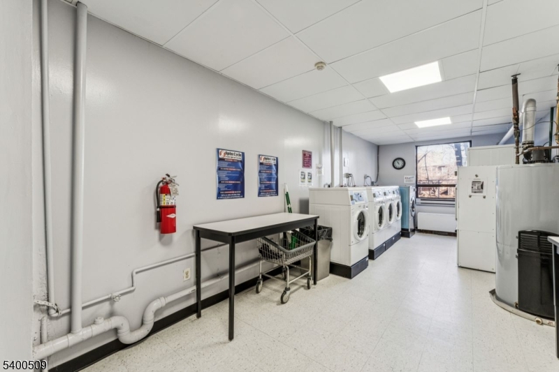 170 Lafayette Avenue, Unit 11E Passaic, NJ 07055 - Photo 22 of 32 a living room with furniture and a refrigerator