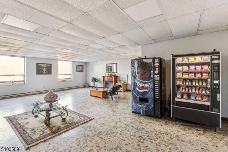 170 Lafayette Avenue, Unit 11E Passaic, NJ 07055 - Photo 26 of 32 a living room with furniture a window and gym equipment