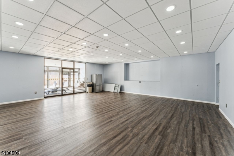 170 Lafayette Avenue, Unit 11E Passaic, NJ 07055 - Photo 32 of 32 an empty room with wooden floor and windows