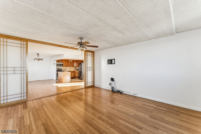 170 Lafayette Avenue, Unit 11E Passaic, NJ 07055 - Photo 6 of 32 a view of empty room with wooden floor