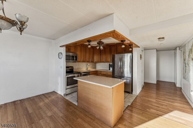 170 Lafayette Avenue, Unit 11E Passaic, NJ 07055 - Photo 10 of 32 a kitchen that has a sink and a stove in it