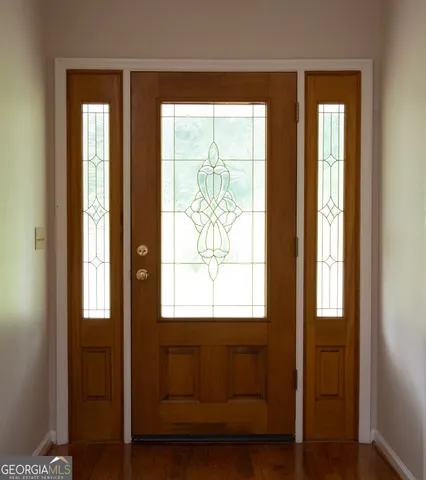 a view of front door with wooden floor
