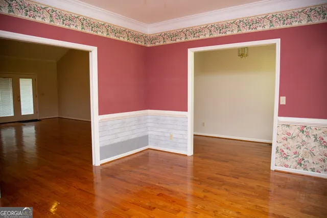 a view of an empty room with a fireplace and a window