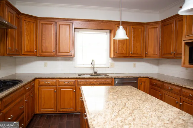 a kitchen with granite countertop cabinets and black stainless steel appliances