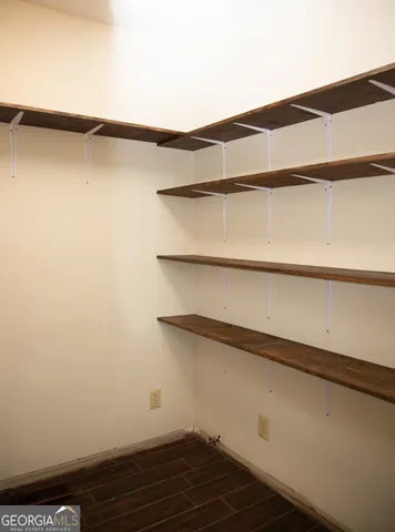a white toilet sitting next to a blue wall