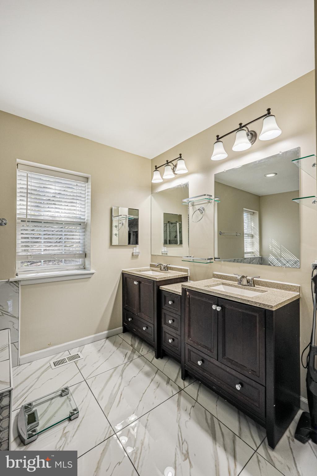 14816 Bushy Park Road Woodbine, MD 21797 - Photo 17 of 40 a spacious bathroom with a granite countertop double vanity sink and mirror