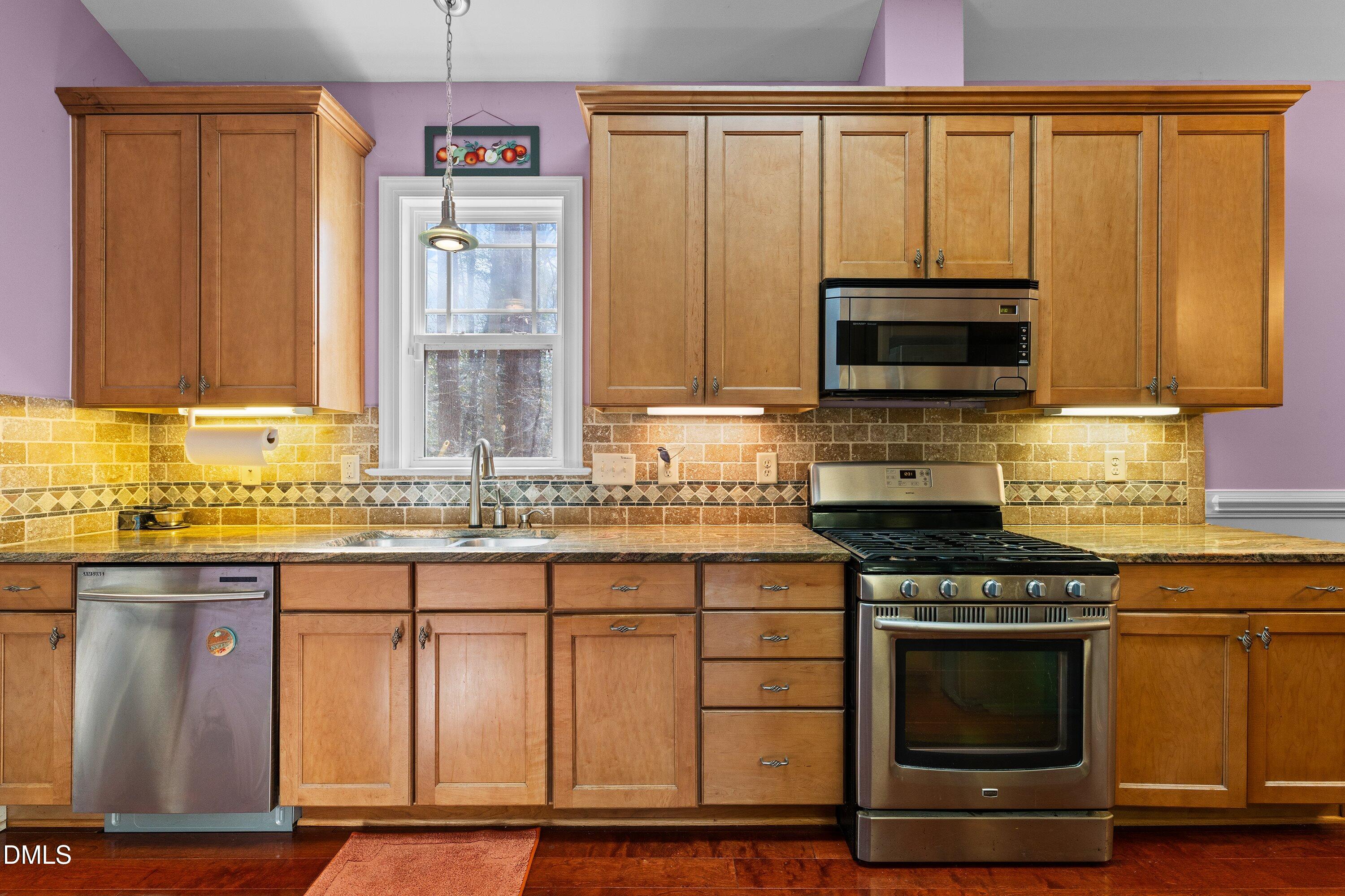 9713 Lake Wheeler Road Raleigh, NC 27603 - Photo 12 of 18 a kitchen with granite countertop a stove top oven cabinetry a sink and dishwasher