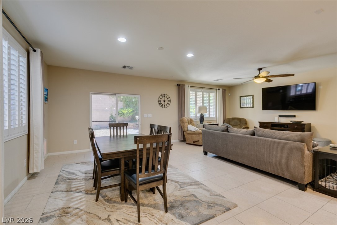 7375 Campbell Ranch Avenue Las Vegas, NV 89179 - Photo 42 of 45 An inviting open floorplan seamlessly connects the dining area with a comfortable living space, featuring access to a private yard.