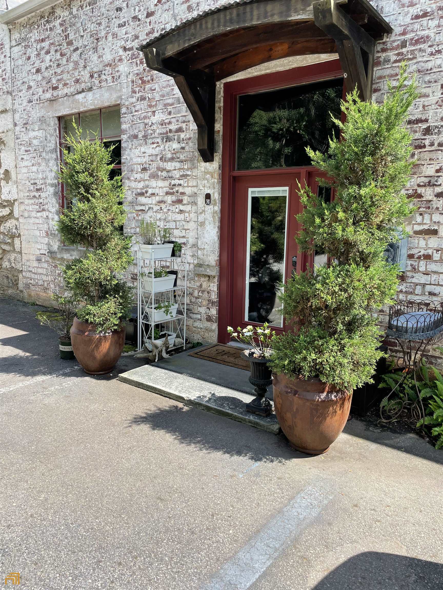 a couple of potted plants in front of door