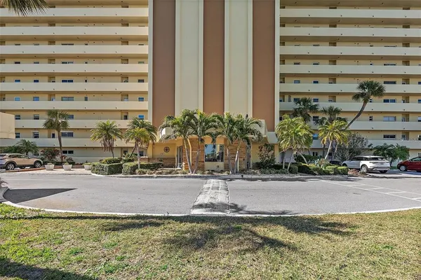 a front view of a building with a yard