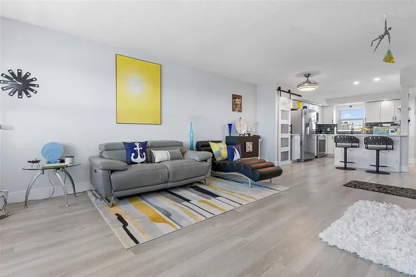 a living room with furniture and kitchen view