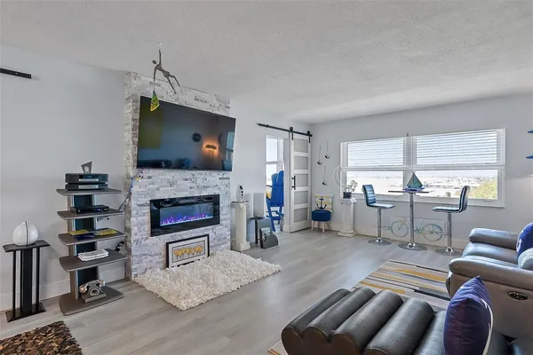 a living room with furniture a fireplace and a flat screen tv