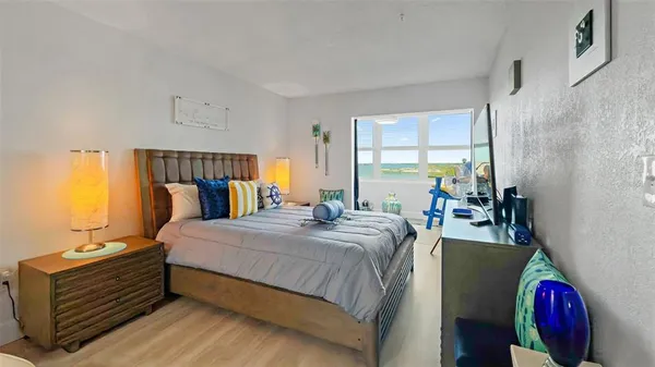 a large bed sitting in a bedroom next to a window